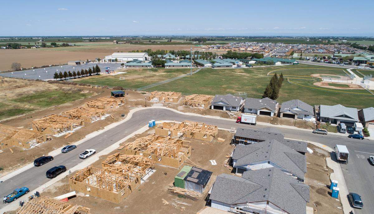 New homes being built by Self-Help Enterprises behind Walnut Grove School as part of the Villages of Patterson development in Patterson, Calif., on Tuesday, April 12, 2022.