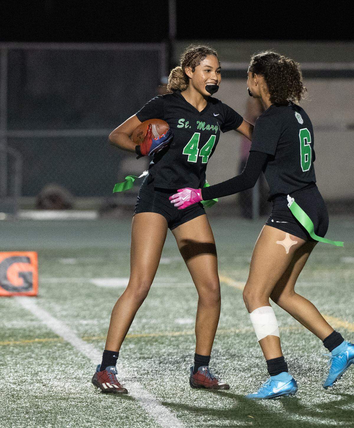 St. Mary’s Larissa Hackley (44) and Savanna Jones celebrate a touchdown during the Sac-Joaquin Section Division I girls flag football playoff game with Gregory at St. Mary’s High School in Stockton, Tuesday, Oct. 29, 2024. St. Mary’s won the game 46-36.