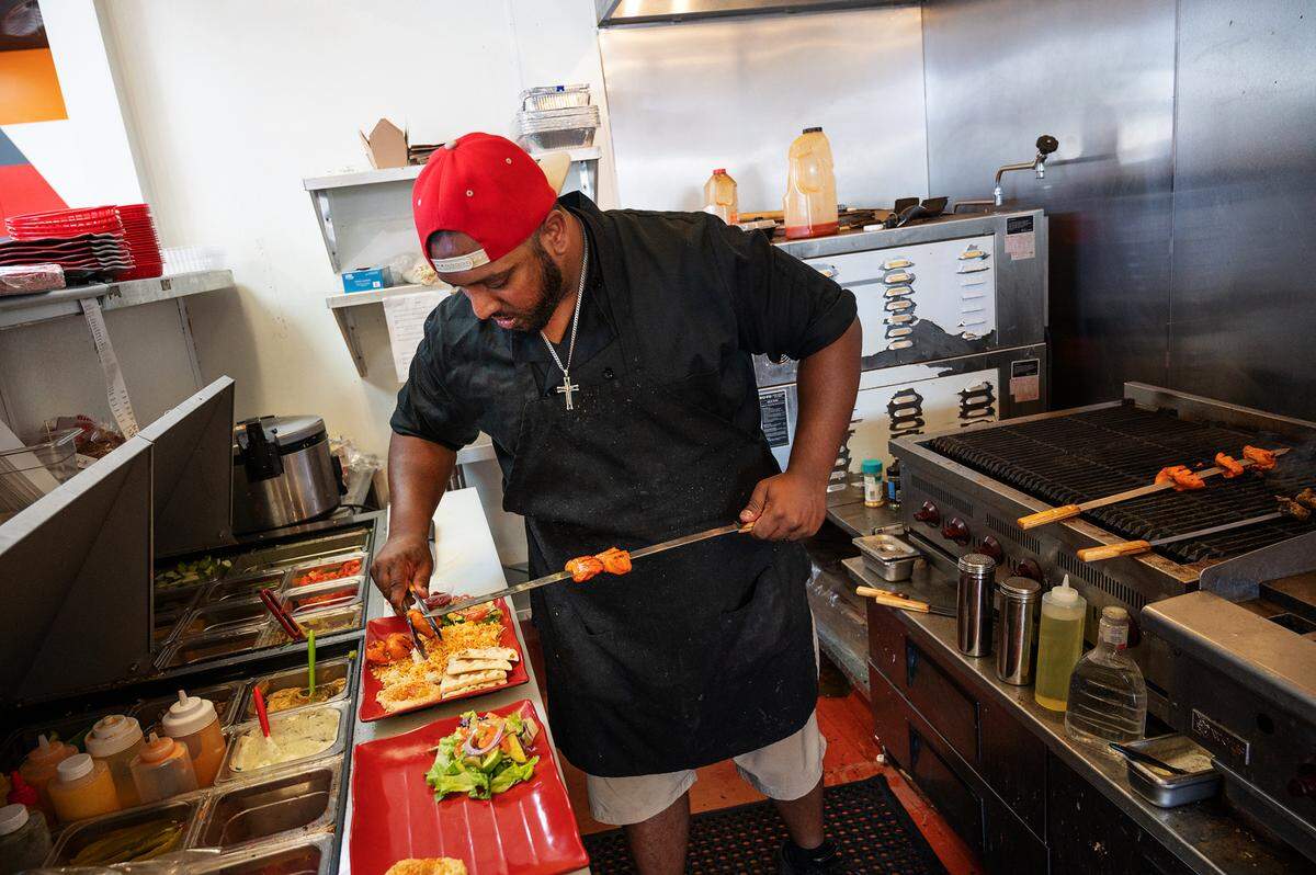 Chef Ryan Reddy plates a kebab platter at BBQ Blaze Mediterranean Fusion in Salida, Calif., on Thursday, Sept. 9, 2021.