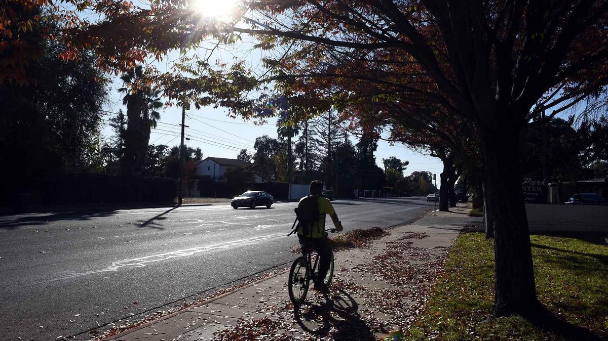 A cyclist rides west on the 1700 block of Scenic drive Friday afternoon, November 15, 2019, in Modesto, Calif.