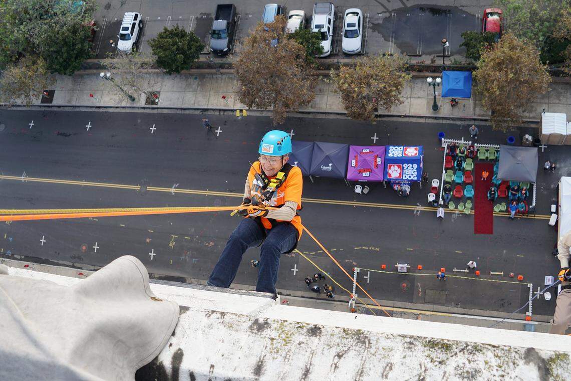 The late Modesto City Councilwoman Jenny Kenoyer, then 81, rappels down the side of the the historic downtown Stockton Medico-Dental Tower during the 2016 Community Hospice fundraiser Over the Edge.