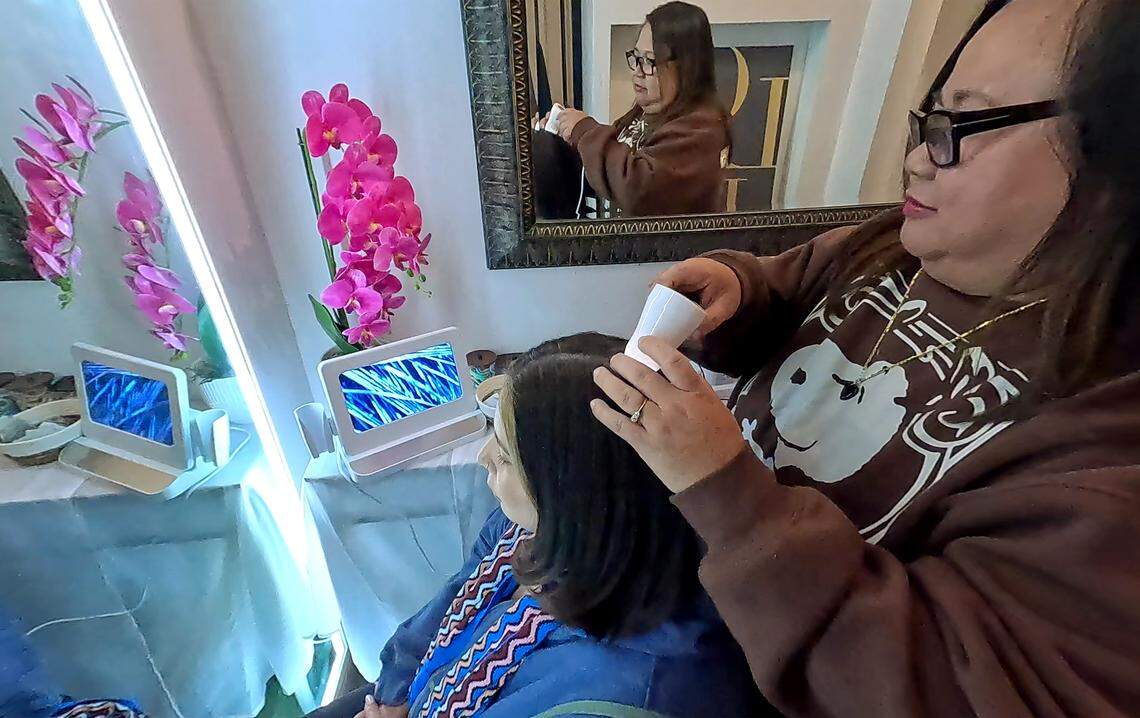 Marife Ronquillo analyzes the scalp of Maria Figueroa and before a Korean head spa at K Glow Day Spa in Modesto, Tuesday, Feb. 25, 2026.