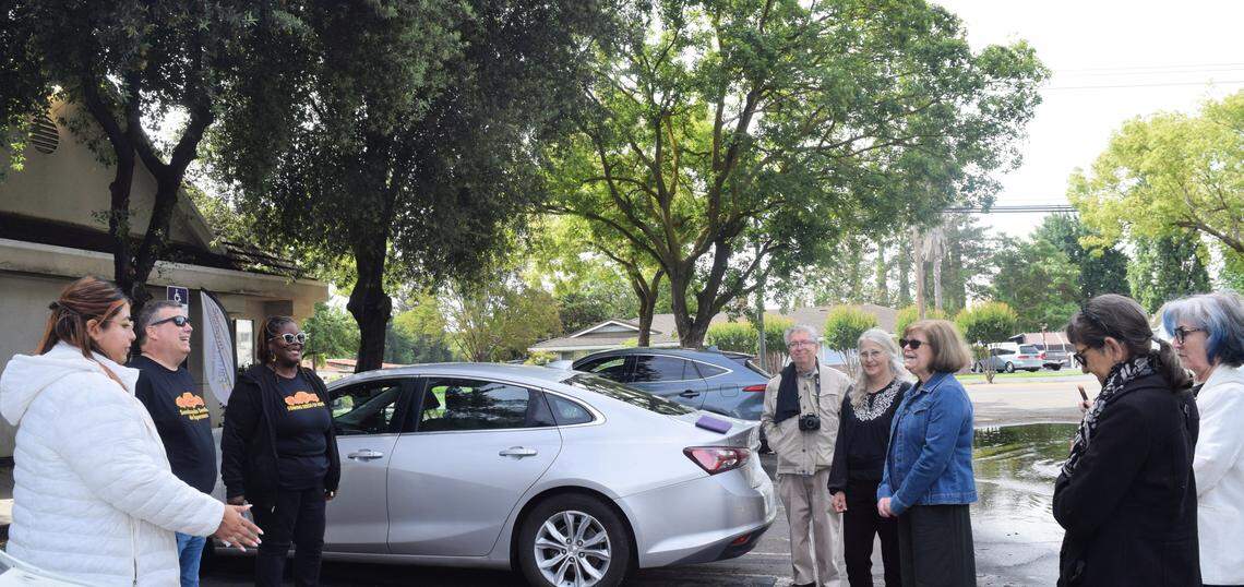 Latricia Beasley-Day and pastor Andrew Sampson of the Church of the Brethren-Modesto lead a group in a prayer while waiting for the bus to come for the Seeds of Hope pilgrimage on April 25, 2026.
