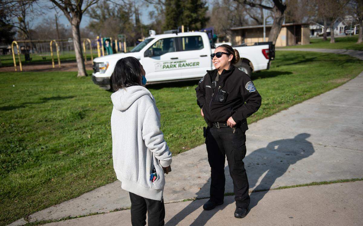 City of Modesto Park Ranger Ivonne Salamanca talks with Dolores Rosas at Cesar Chavez Park in Modesto, Calif., Friday, Jan. 27, 2023.