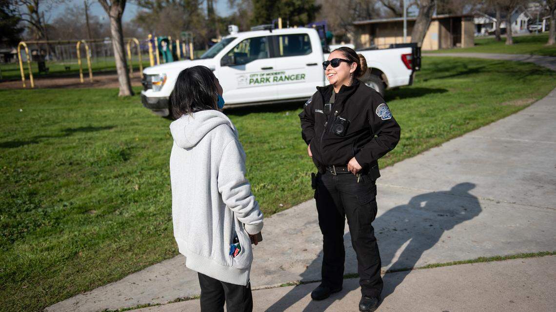 City of Modesto Park Ranger Ivonne Salamanca talks with Dolores Rosas at Cesar Chavez Park in Modesto, Calif., Friday, Jan. 27, 2023.