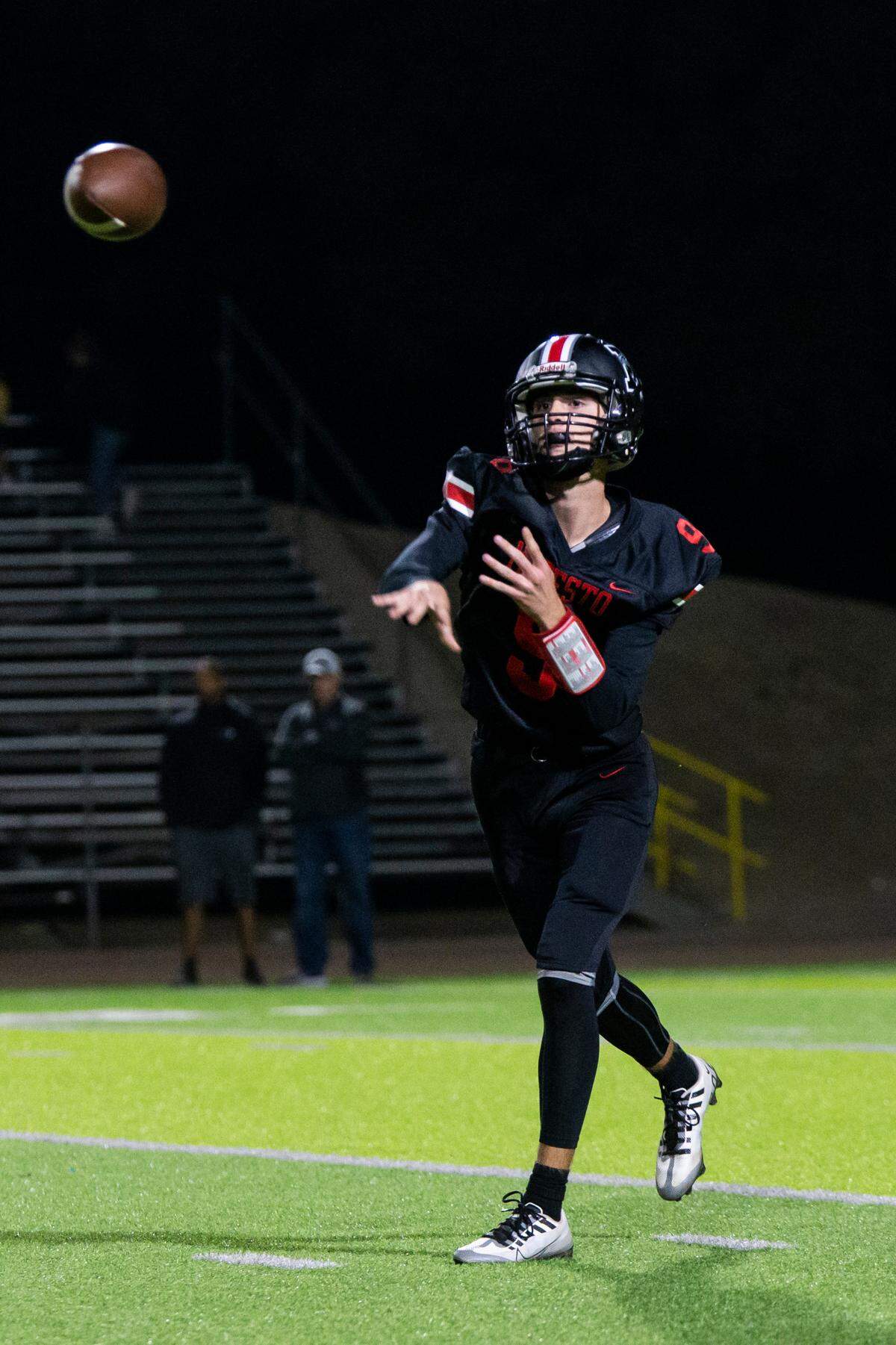 Eli McCabe, 9, of Modesto High throws a pass up field against Pitman High Friday Oct. 21, 2022.