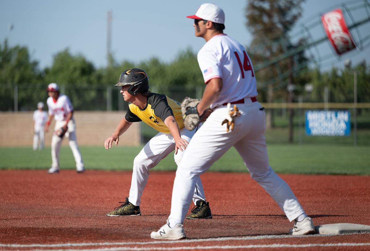 Hughson’s Caleb Wilson takes a lead off first base during the Trans Valley League game with Ripon at Mistlin Park in Ripon, Calif., on Wednesday, April 27, 2022. Ripon won the game 11-1.