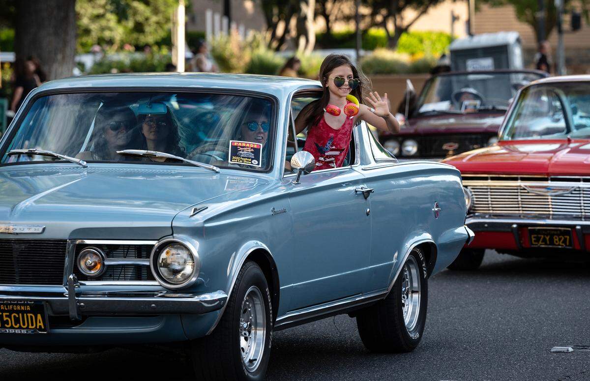 Classic car owners cruise along I Street during the North Modesto Kiwanis Club’s “American Graffiti” car parade in Modesto, Calif., on Friday, June 10, 2022.