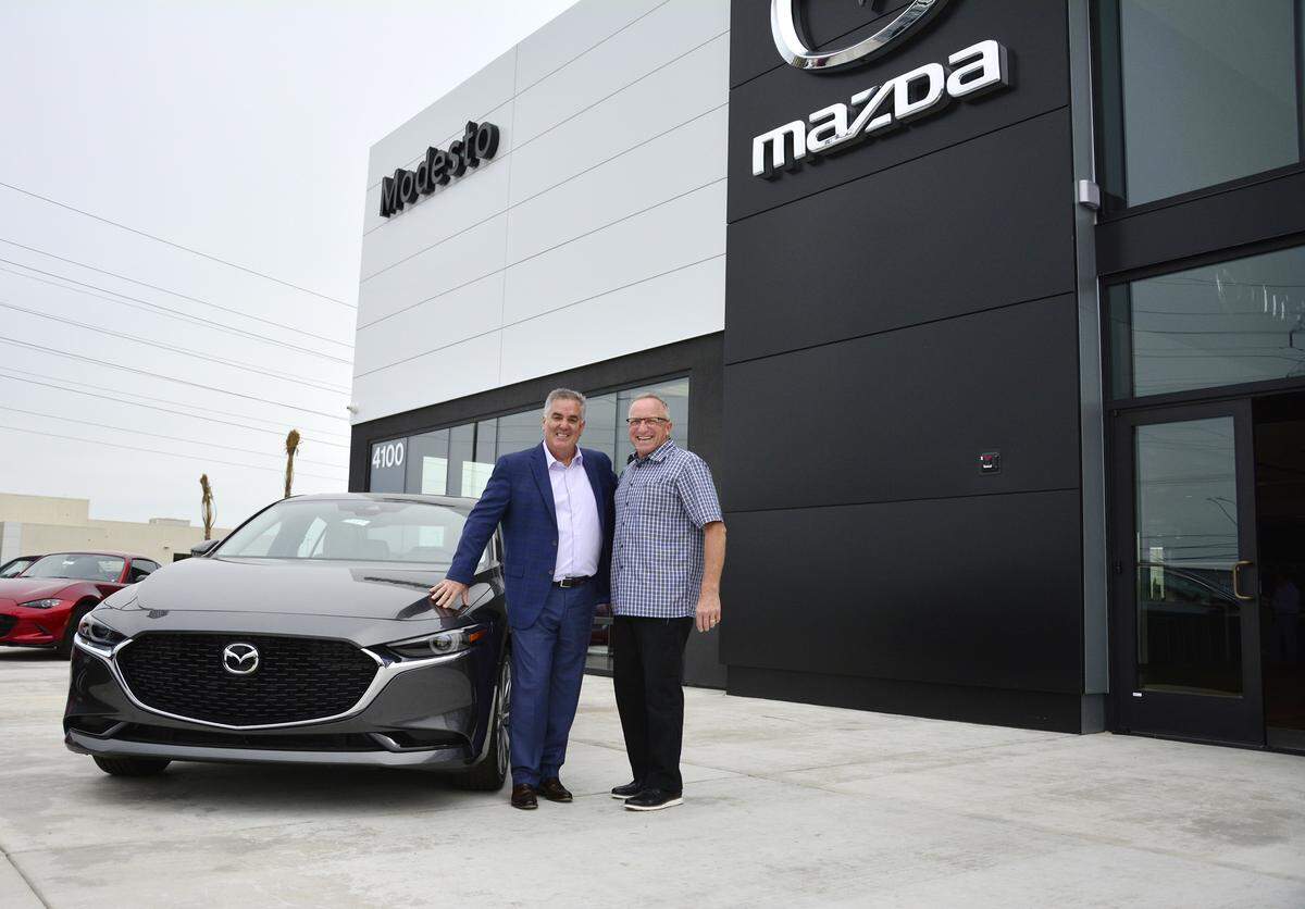 The new Modesto Mazda dealership on McHenry Avenue opened at the end of March. Central Valley Automotive President John Gardner (left) and Simile Construction CEO Guy Simile stand in front of the dealership they built.
