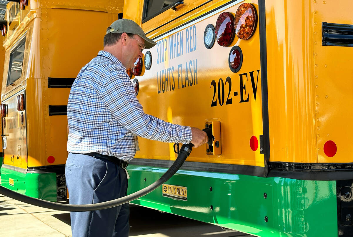 A Modesto City Schools official charges an electric bus on July 31, 2023.