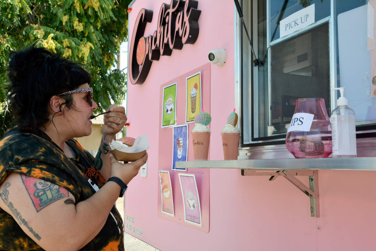 Adriana Townsend of Ceres tries one of the treats at the new Conchitas Truck in Denair, Calif. July 30, 2021.