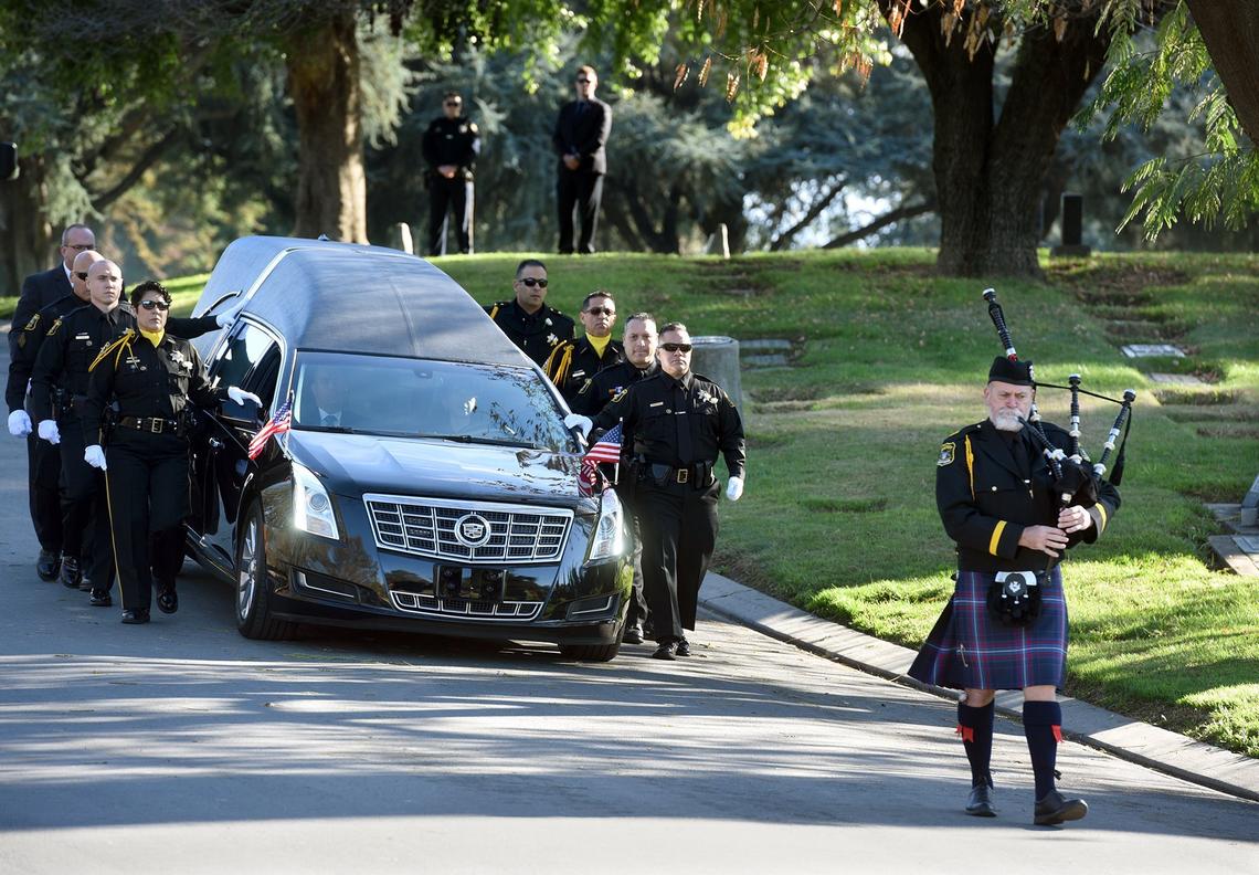 Bagpiper George Harcrow leads the hearse toward the burial service for Stanislaus County Sheriff’s deputy Antonio “Tony” Hinostroza at Lakewood Memorial Park in Hughson, Calif. Thursday December 6, 2018.