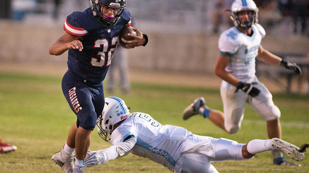 Modesto Christian’s Patrick Garcia sidesteps El Capitan’s Kevin Reid during the non-league game in Salida, Calif., on Friday, September 7, 2018. Modesto Christian won the game 47-8.