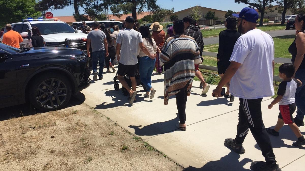 Police allow parents Monday to enter the Cesar Chavez Junior High School campus after determining everything was secure.