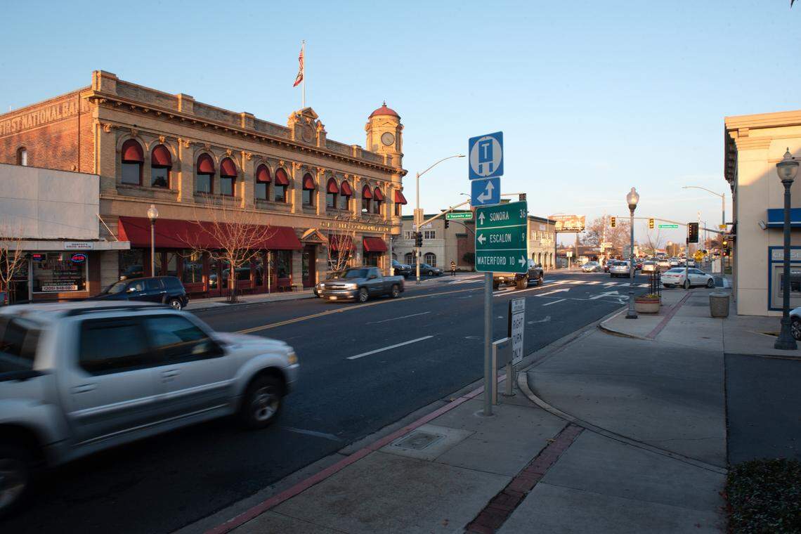 Motorists on Highway 108 pass through downtown Oakdale, Calif., Friday, Dec. 18, 2020.