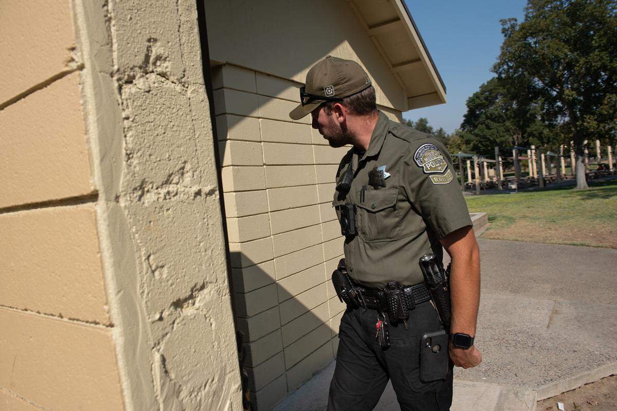 Modesto park ranger Justin Rocha investigates a call about a disturbance in the restroom at Downey Park in Modesto, Calif., on Friday, September 9, 2022.