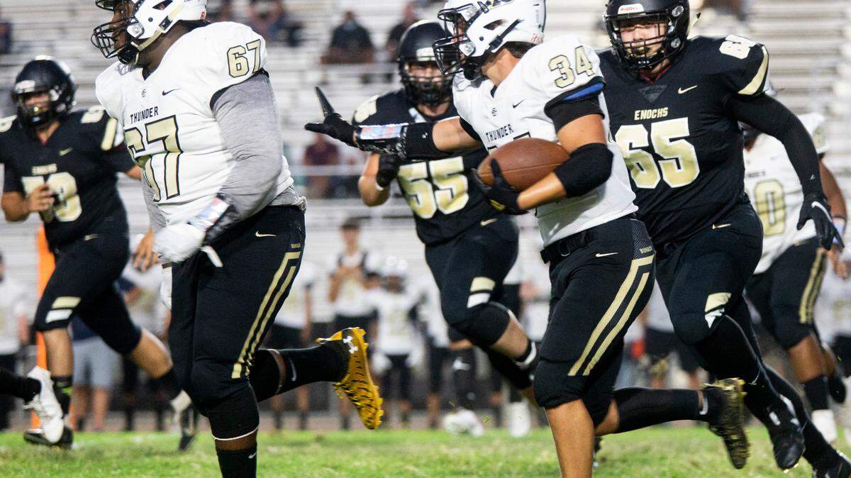 Payton Johnson, 34, works his way upfield with the help of teammate Cornell Gilkey, 67 as Enochs High comes up from behind. Enochs High vs Buhach Colony football at Johansen Friday, Sept. 3, 2021.