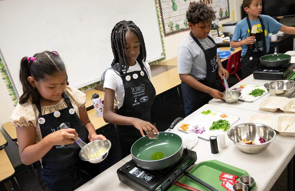 From left to right, Allison Fuentes, Olivia Hodges, Aries Saffell, and Meker Ford prepare a veggie fried rice meal as part of the Junior Chef after school program at Sipherd Elementary School in Modesto, Calif., Thursday, Sept. 19, 2024.