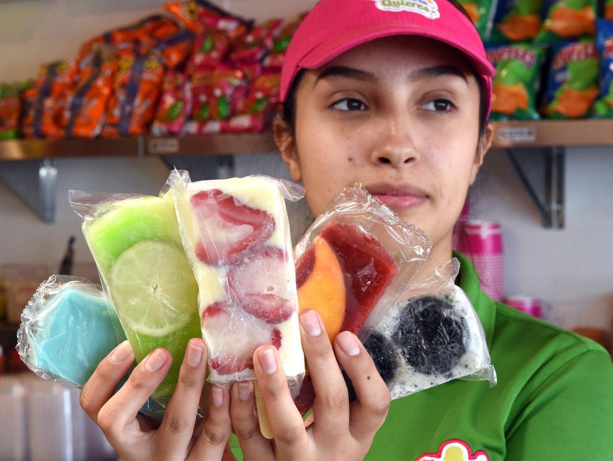 Employee April Fuentes holds an assortment of paletas on Wednesday afternoon June 19, 2019 at La Michoacana Plus in Modesto, Calif.