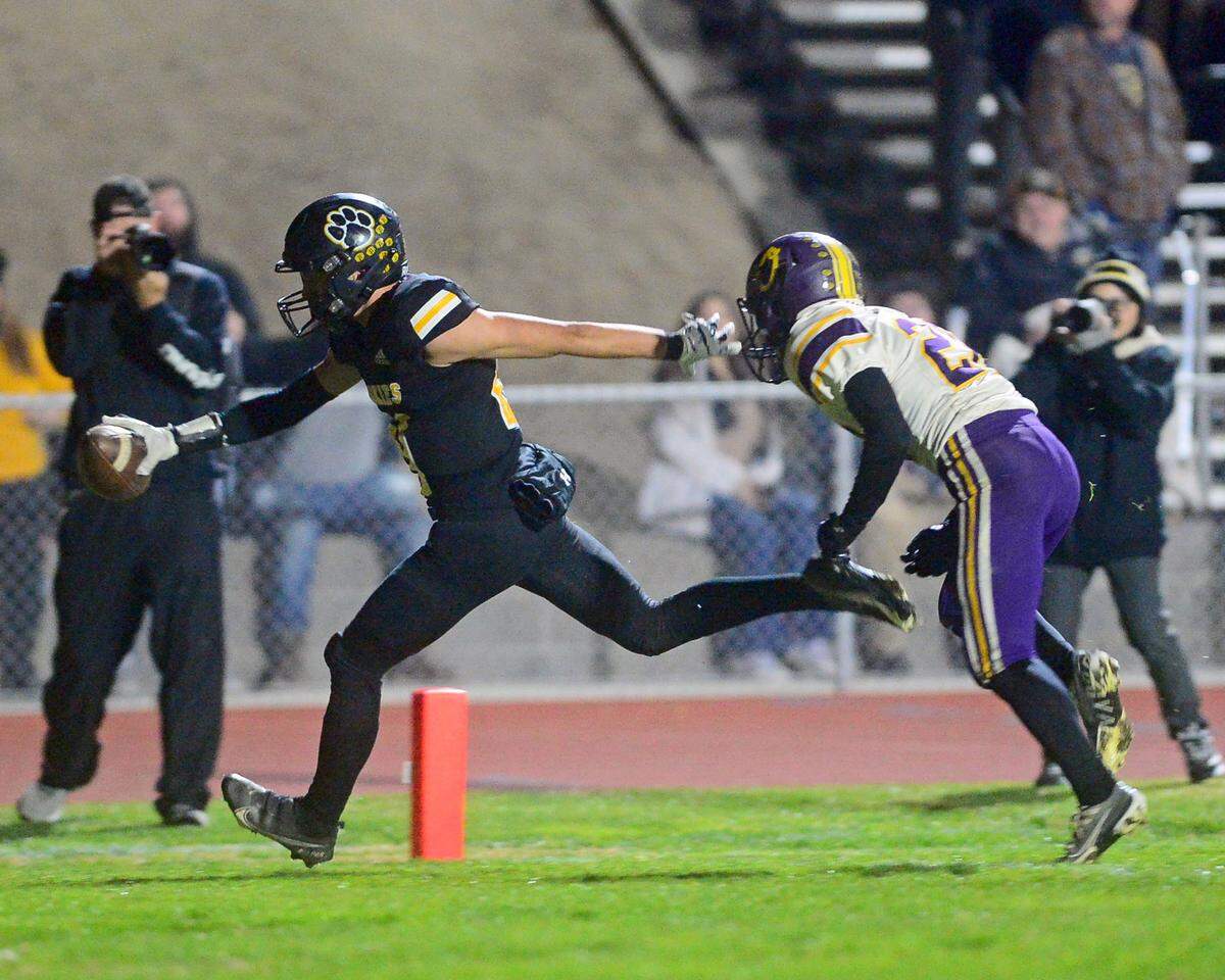 Hughson receiver David Delgado reaches the ball out and runs in the end zone for a touchdown during a Sac-Joaquin Section Division VI playoff game against Orestimba in Hughson, California, on Nov. 18, 2022. Hughson won 21-17.