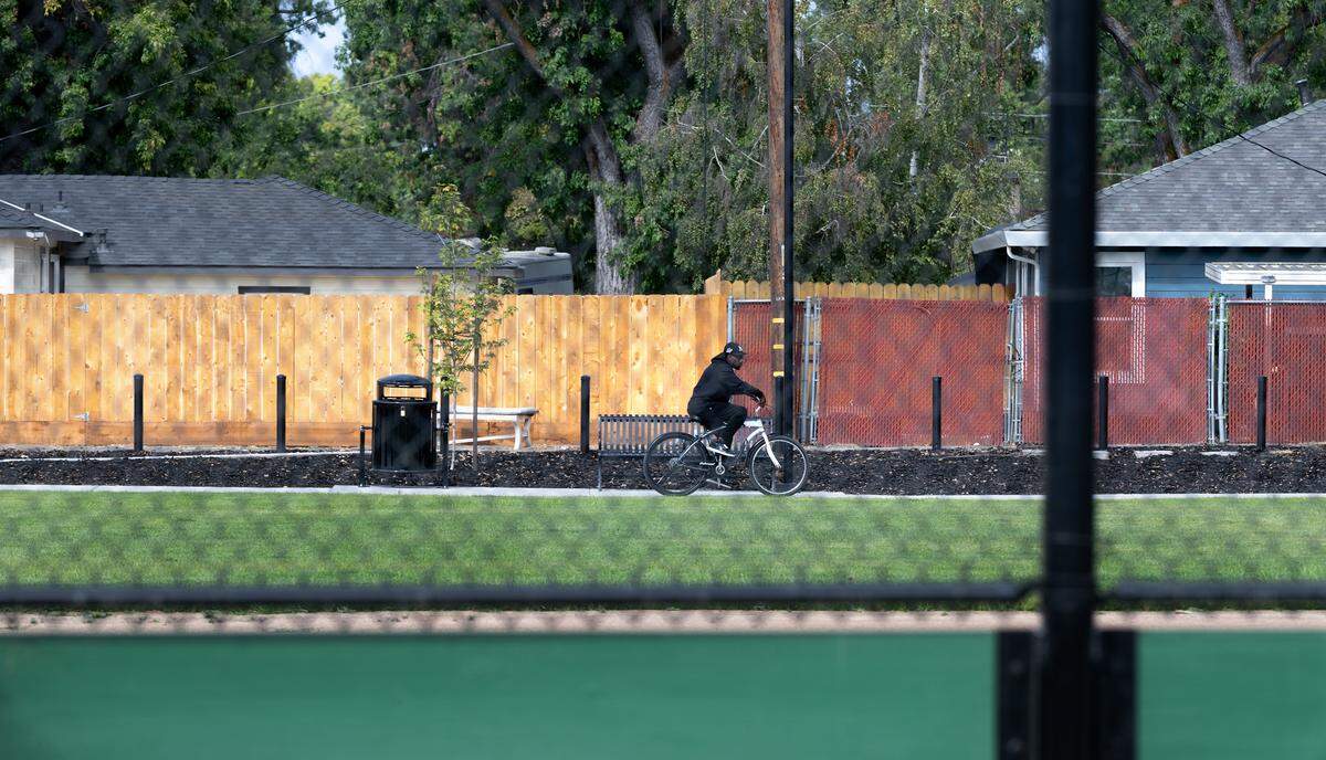 A pedestrian pathway lines the perimeter of Pike Park in Modesto, Wednesday, Oct. 1 2025.