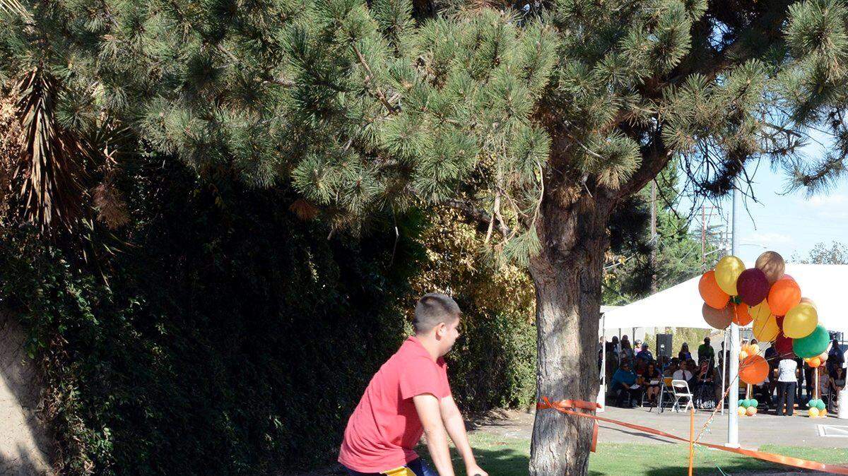 Children check out dedication festivities Thursday (09-18-14) as they bike by on the Helen White Memorial Trail in Modesto, CA.