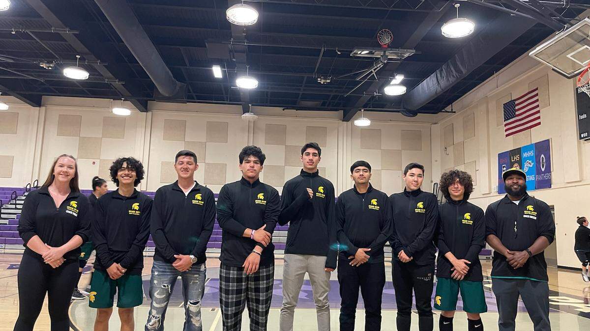Davis High boys volleyball players pose for a picture with head coach Renaldo Rucker and assistant coach Molly Fonda. Davis is the first Modesto City School to have a boys volleyball team.