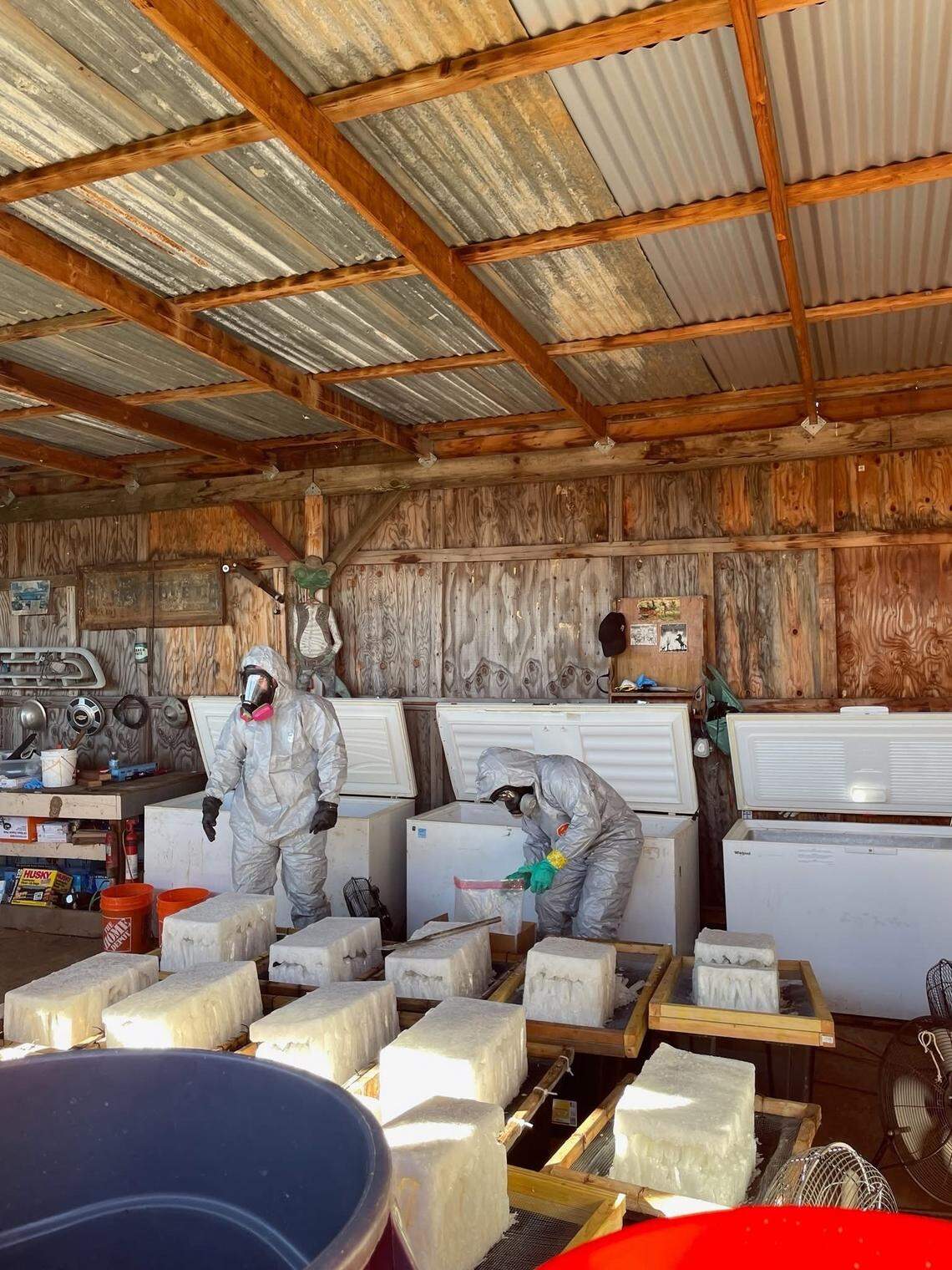 Investigators wearing protective gear process large blocks of suspected methamphetamine inside a structure tied to a multi-agency narcotics investigation. Authorities said the five-month probe targeted an alleged drug trafficking organization operating in Northern California.