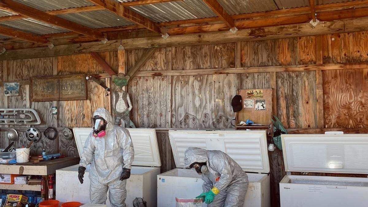 Investigators wearing protective gear process large blocks of suspected methamphetamine inside a structure tied to a multi-agency narcotics investigation. Authorities said the five-month probe targeted an alleged drug trafficking organization operating in Northern California.