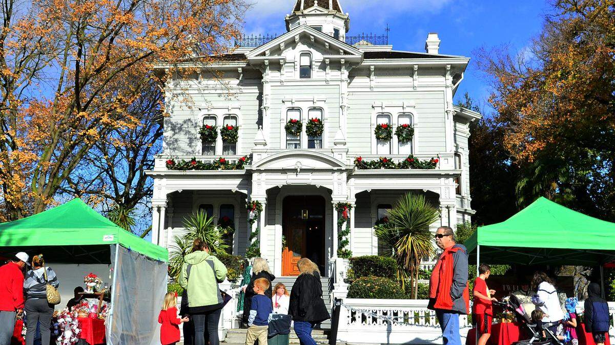 Visitors walk past the McHenry Mansion during the 2018 Dickens Faire in downtown Modesto.