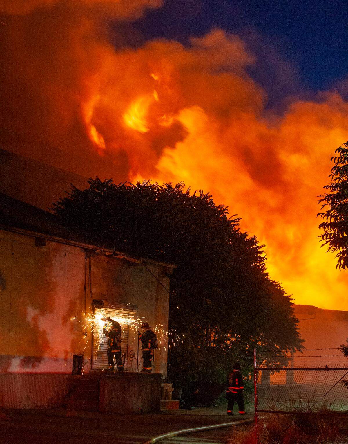 Modesto Fire Department crews battle a huge structure fire at a warehouse at the corner of Tully Road and Ninth Street on Sunday, July 7, 2019.
