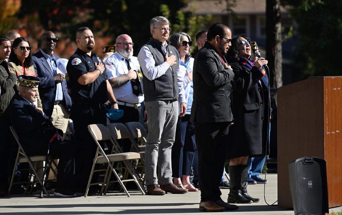 Patti Castillo Davis, right, sings the national anthem during the Veterans Day Ceremony in Modesto, Calif., Saturday, Nov. 11, 2023.