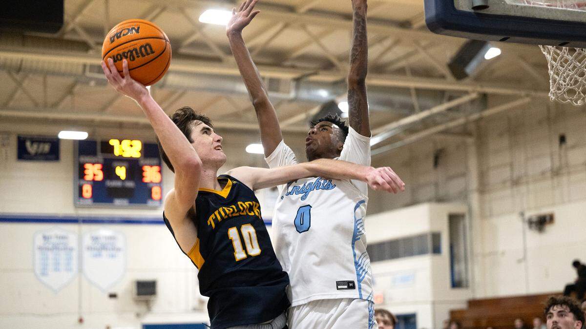 Turlock’s Andrew Johnson scores over Downey’s Reuben Lewis in the Central California Athletic League game at Downey High School in Modesto, Calif., Friday, Jan. 19, 2024.