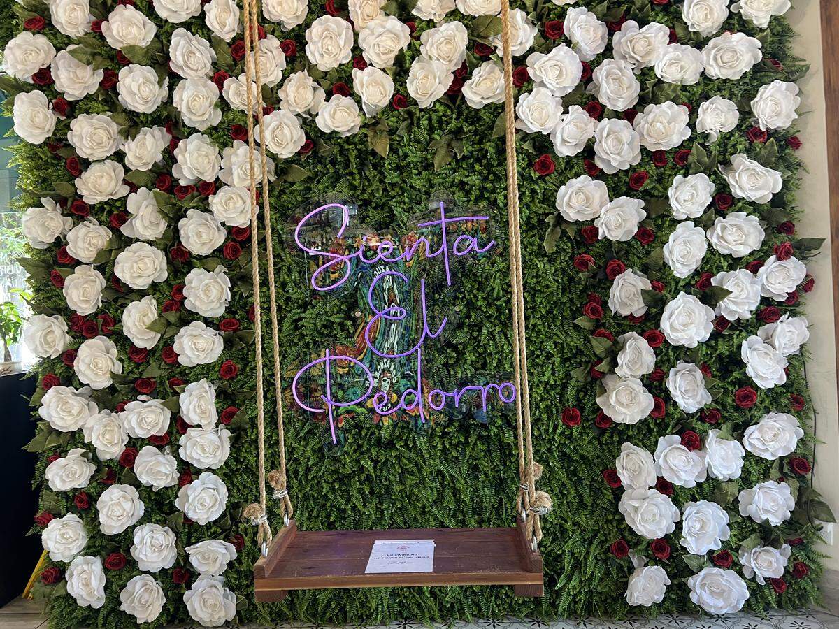 A swing hung from the ceiling, and a neon sign framed by artificial flowers playfully read, “Sienta el Pedorro” — which is slang for “sit your butt down” at Con Azucar Cafe in Modesto.