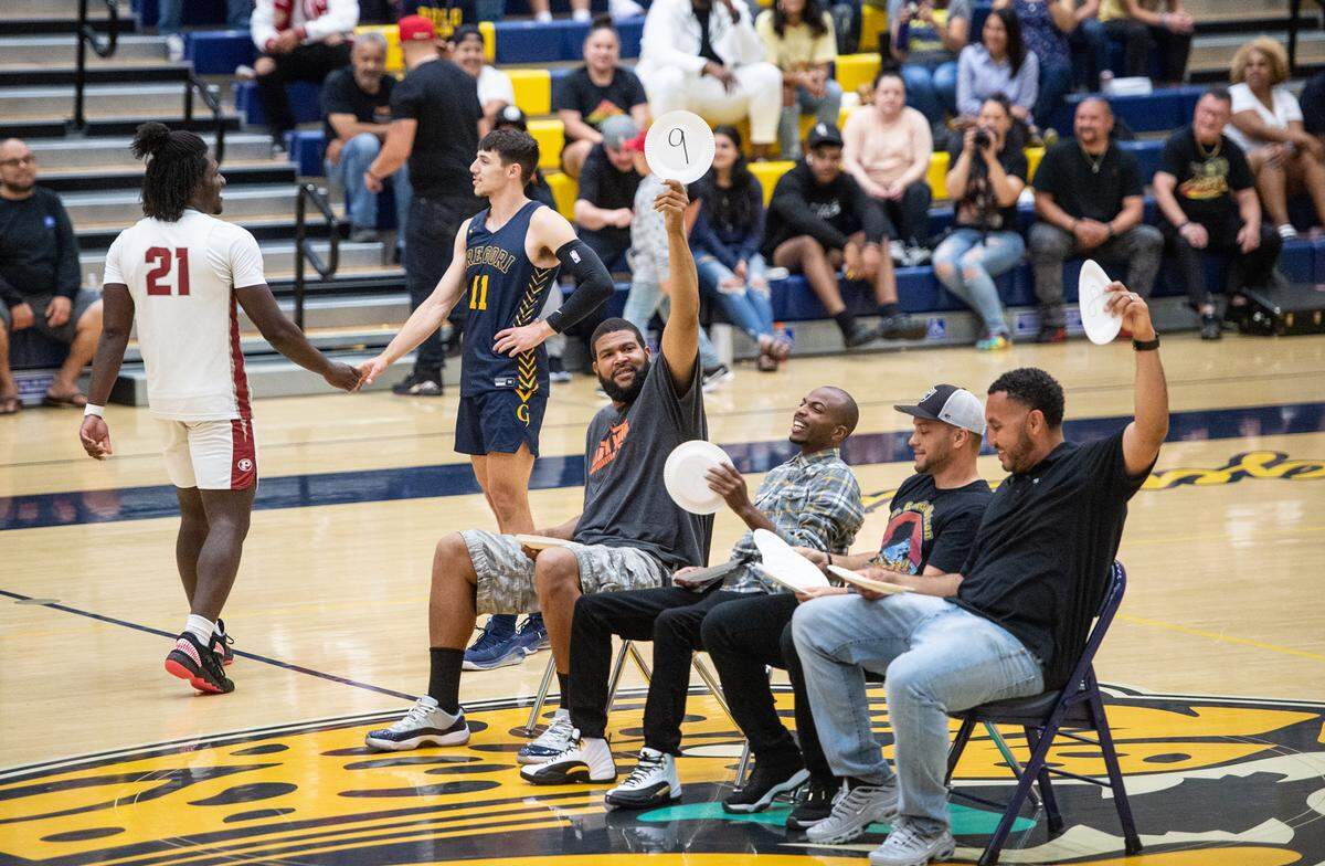 Judges score the dunk of Precious Nnaji (21) as he is congratulated by Gregory’s Kyle Monk before the Six-County Senior All-Star Basketball Game at Gregori High School in Salida, Friday, May 6, 2022. Nnaji won the contest.