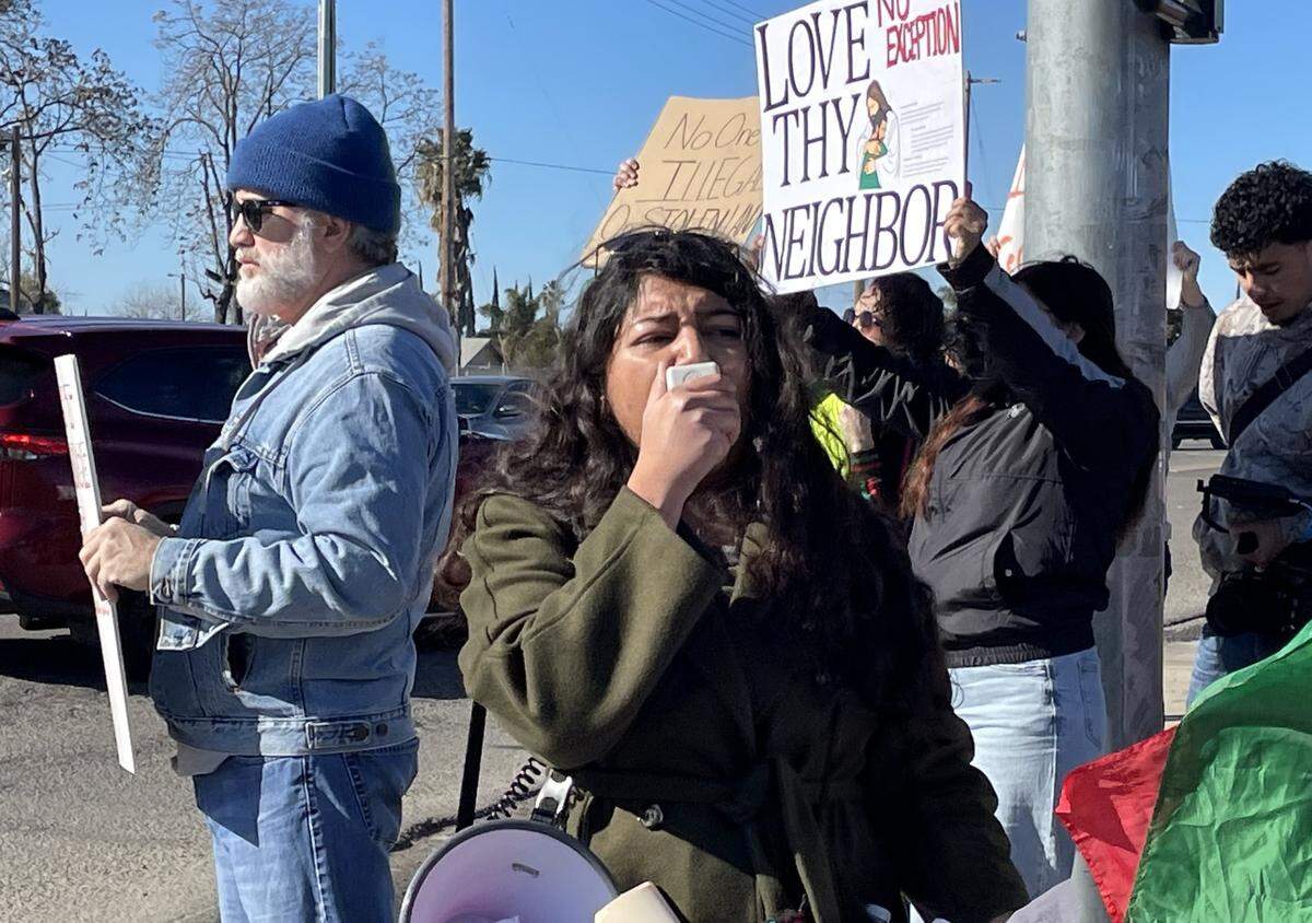 Julissa Ruiz Ramirez leads a chant at a protest against mass deportations on Feb. 8, 2025, in Modesto, Calif. She is a co-founder of the Central Valley Black, Indigenous and People of Color Coalition.