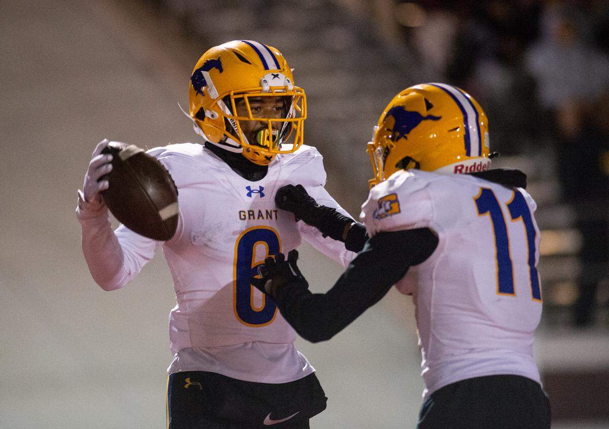 Grant’s Kyrell Goss-Pruitt (6) and Kenyon Shabazz (11) celebrate a touchdown during a Sac-Joaquin Section Division III semifinal with Patterson in Patterson, Calif., Friday, Nov. 18, 2022. Grant won 80-44.