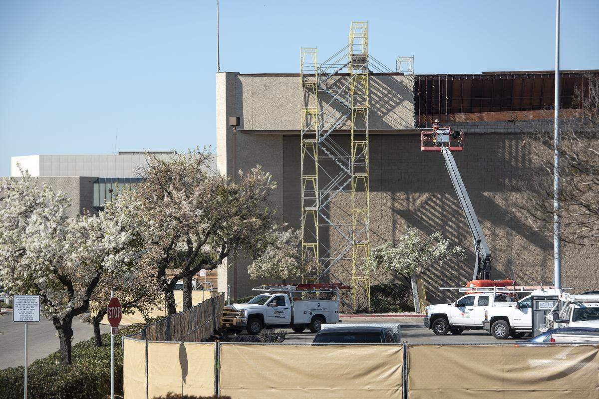 A construction crew works on the former Sears store at Vintage Faire Mall in Modesto, Calif., on Thursday, Feb. 6, 2020.