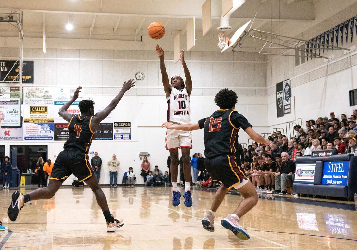 Modesto Christian’s BJ Davis launches a jump shot during the Modesto Christian Holiday Hoop Classic championship game with Clovis West at Modesto Christian High School in Salida, Calif., Friday, Dec. 30, 2022.