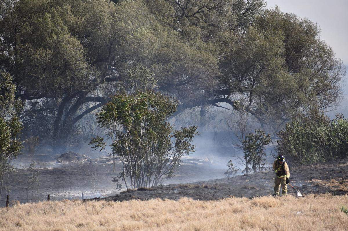 Firefighters from across Stanislaus County battle a vegetation fire near Modesto’s airport neighborhood on Monday afternoon, May 2, 2022.