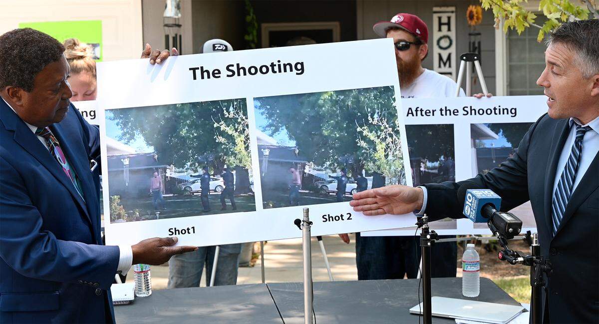 Attorneys Ben Nisenbaum, right, and John Burris, left, show still frames from a cell phone video of the shooting of Paul Chavez Jr. during a news conference to announce a wrongful death lawsuit for the fatal shooting by Modesto Police on July 14. Photographed on Estrada Way in Modesto, Calif., on Tuesday, July 26, 2022.
