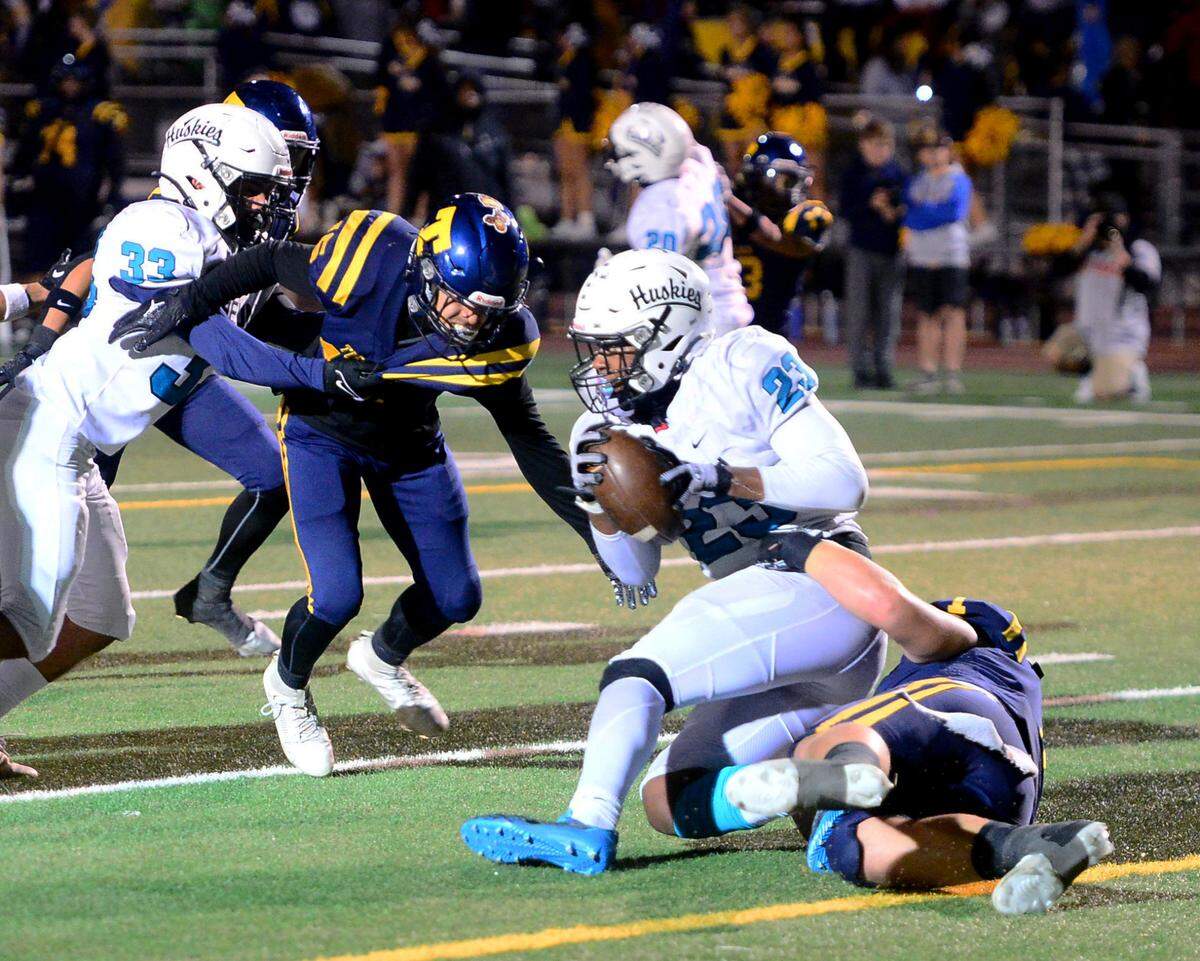 Turlock’s Owen Miller (1) takes down Sheldon running back Zayden Learson (23) for a safety during a CIF Sac-Joaquin Section Football Division I playoff game between Turlock High School and Sheldon High School at Turlock High School in Turlock, California on Nov. 3, 2023.