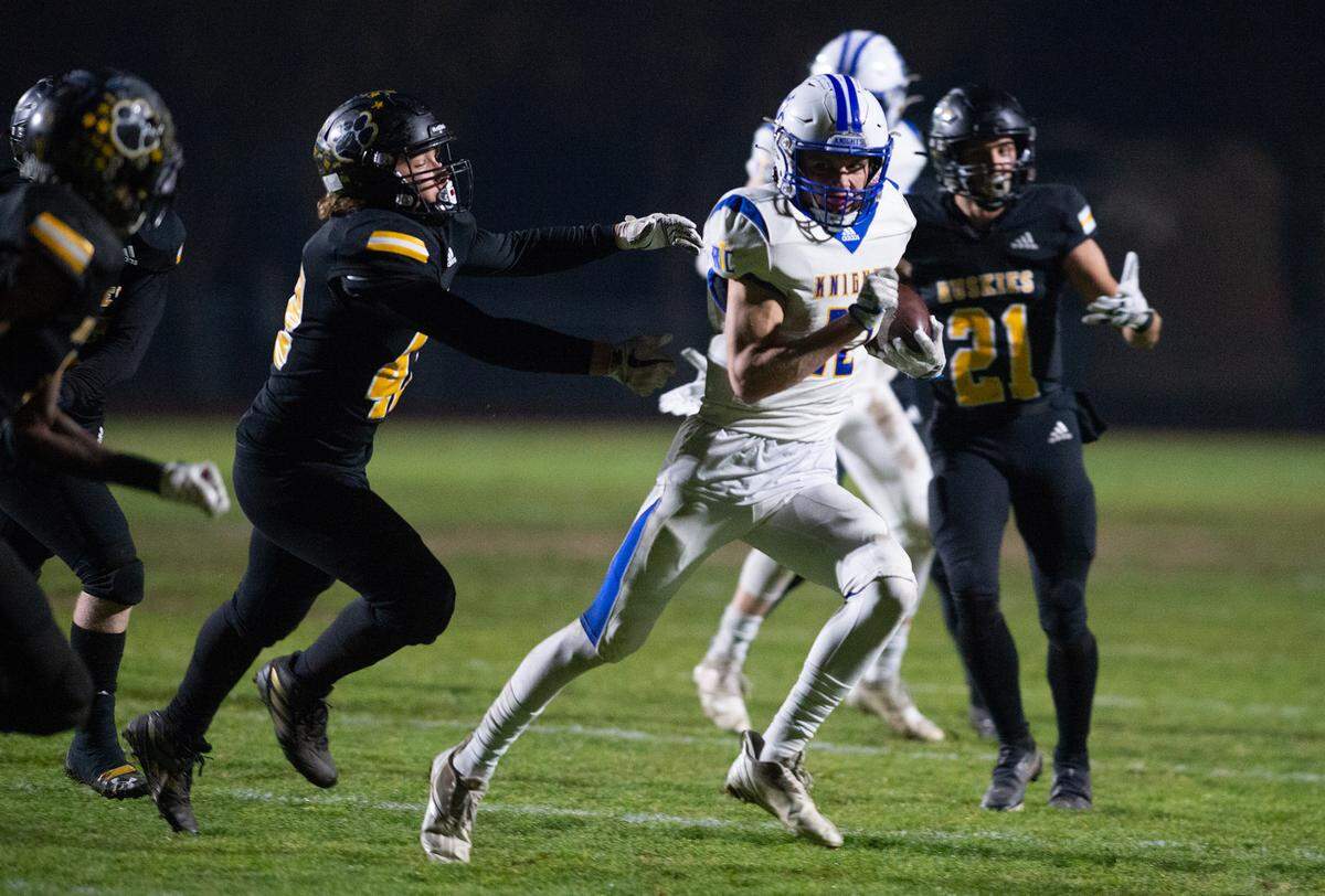Ripon Christian’s Derek VanElderen breaks away from Hughson defenders on a touchdown run during the CIF Division 5-AA Northern California Regional Bowl Game on Friday, Dec. 2, 2022 in Hughson, Calif..