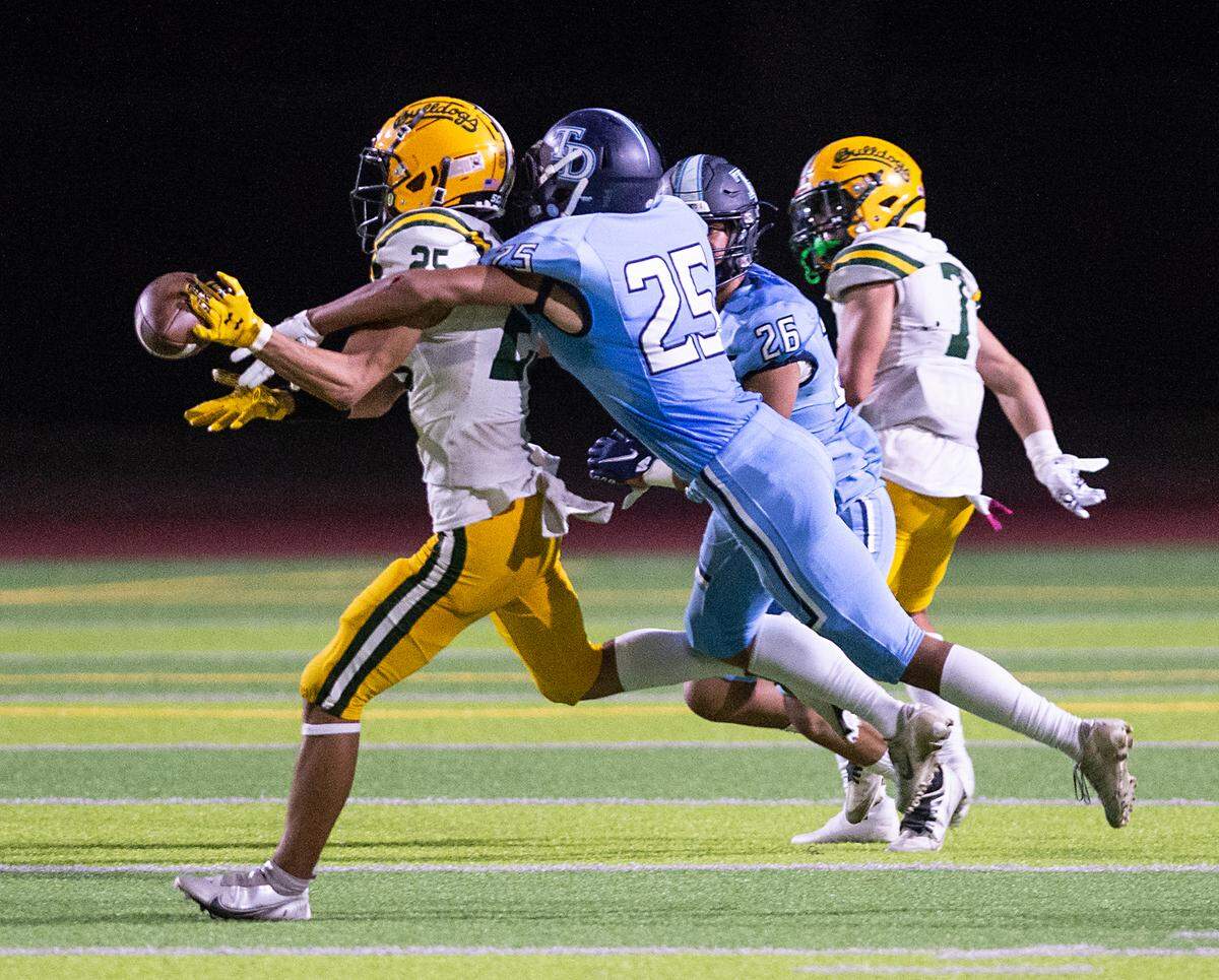 Downey’s Antonio Vizcaino breaks up a pass to Tracy’s Manny Epps during the nonleague game at Downey High School in Modesto, Calif., on Friday, September 16, 2022.