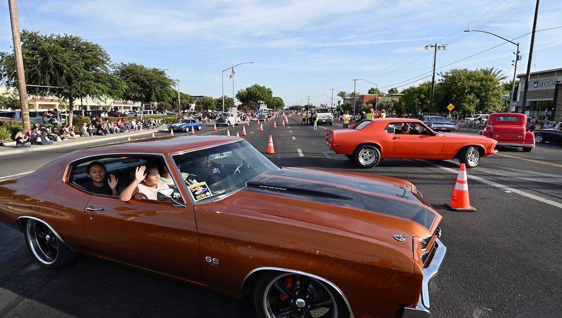 Classic car owners make the turn at Briggsmore and McHenry Avenues during the Graffiti Parade in Modesto, Calif., Friday, June 9, 2023.