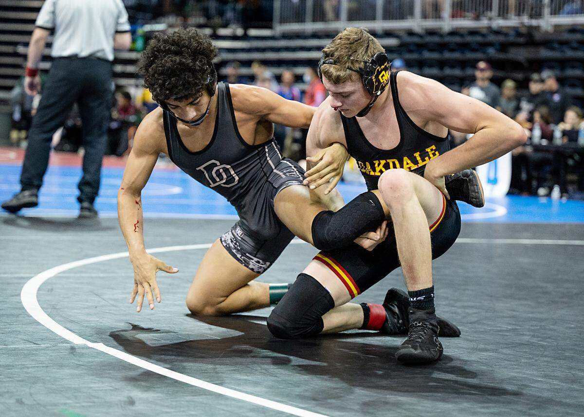 Oakdale’s Colton Silva, right, and Damion Elliot of Del Oro compete in the 132-pound championship match during the CIF Sac-Joaquin Section Masters Wrestling Tournament at the Stockton Arena in Stockton, Calif., on Saturday, Feb. 19, 2022. Elliot earned a 5-1 decision to win first place.