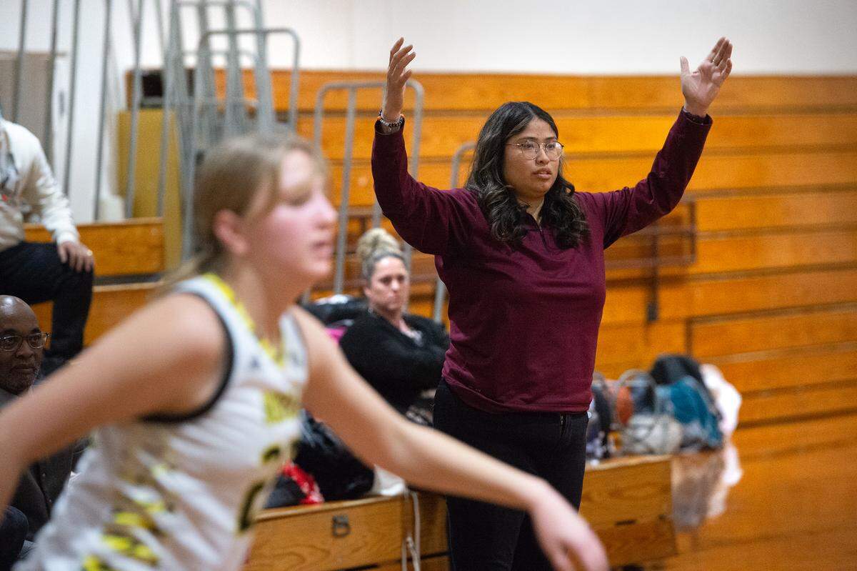 Riverbank coach Janelle Luu signals to her players during the Trans-Valley League game in Hughson, Calif., Tuesday, Jan. 31, 2023.