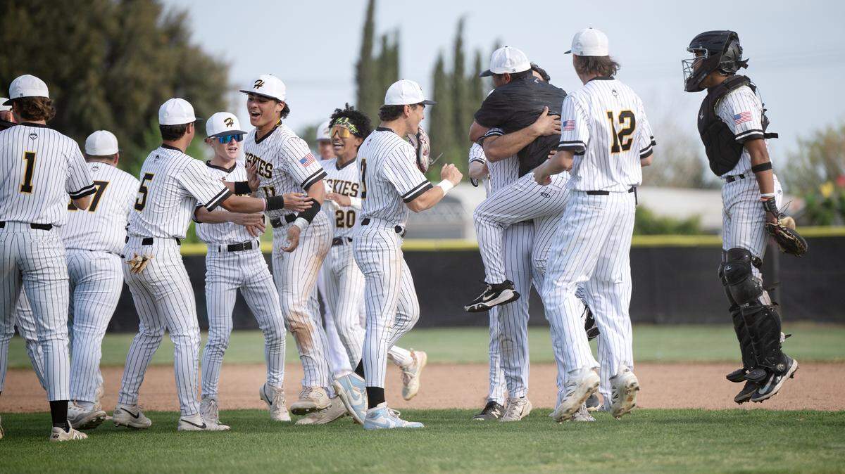 Hughson players celebrate clinching the Trans-Valley League title after a 8-4 win over Hilmar at Hughson High School on Thursday, April 17, 2025.