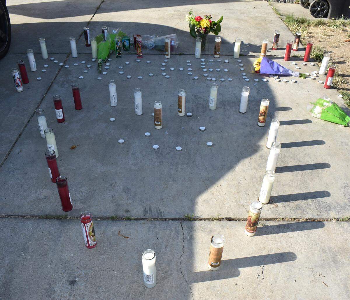 In the driveway of the Ramsey Drive home in Modesto where Michelle Rose Gonzales was fatally shot Tuesday night, June 21, 2022, candles form the shape of a heart and spell out her first name.
