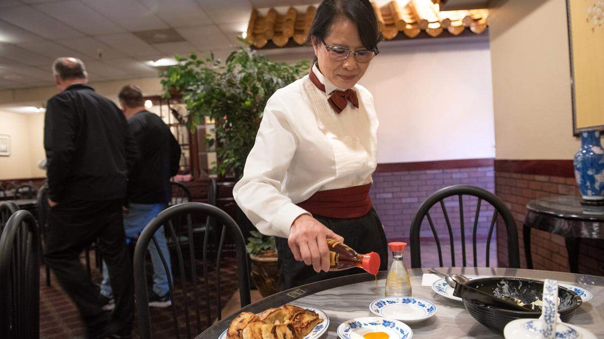 Owner Maria Wong prepares a dipping sauce for potstickers at Beijing Restaurant in Modesto, Calif., Thursday, Dec. 15, 2022.